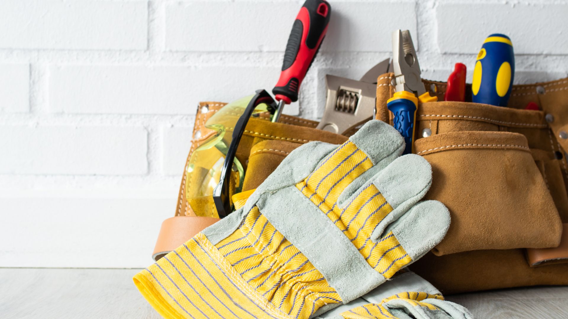 Stock photograph of handyman tools and gloves in a tool belt