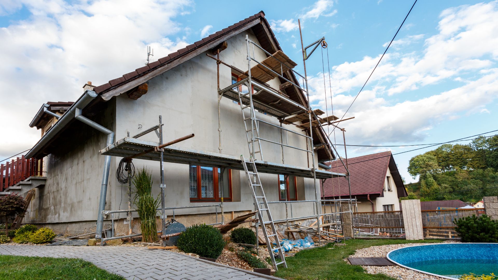 Stock photograph of scaffolding around a house undergoing exterior repairs